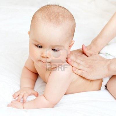 5533376-masseuse-massaging-little-baby-girl-shallow-focus.jpg