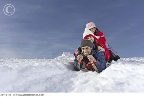Mid_adult_family_snow_sledding_on_winter_day_28410.jpg